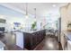 Open layout kitchen with a large island, hardwood floors, stainless steel appliances and granite countertops at 2447 Louisville St, Charleston, SC 29492