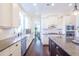 Bright, open kitchen featuring granite countertops, stainless appliances, and white cabinetry at 2447 Louisville St, Charleston, SC 29492