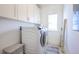 Laundry room with washer and dryer, built-in cabinets, and a window for natural light at 2447 Louisville St, Charleston, SC 29492