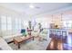 Open-concept living area flowing into the kitchen, featuring hardwood floors and neutral decor at 2447 Louisville St, Charleston, SC 29492