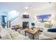 Cozy living room with a fireplace, white sofa, hardwood floors, and staircase at 2447 Louisville St, Charleston, SC 29492