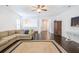 Living room with jute rug, hardwood floors, sectional sofa, and white walls with bright natural light at 2447 Louisville St, Charleston, SC 29492