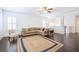 Spacious living room featuring hardwood floors, a jute rug, and an L-shaped sofa at 2447 Louisville St, Charleston, SC 29492