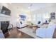 Bright living room with large windows, fireplace, a ceiling fan and comfortable seating at 2447 Louisville St, Charleston, SC 29492
