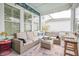 Relaxing screened porch with comfortable seating, stylish decor, and great natural light at 2447 Louisville St, Charleston, SC 29492
