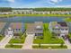 Stunning aerial view of homes lining a serene lake with lush green landscapes and community in the background at 260 Dunlin Dr, Summerville, SC 29486