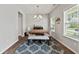 Bright dining room features stylish chandelier, wood table, cushioned bench, and elegant decor at 260 Dunlin Dr, Summerville, SC 29486