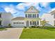 Inviting two-story home showcasing a manicured lawn, two-car garage, and a welcoming front porch at 260 Dunlin Dr, Summerville, SC 29486