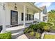 Close-up of a charming front porch with stylish lanterns, neat landscaping, and a welcoming entrance at 260 Dunlin Dr, Summerville, SC 29486