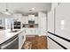 Well-lit kitchen with white cabinets, granite countertops, stainless steel appliances, and wood flooring at 260 Dunlin Dr, Summerville, SC 29486