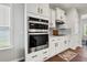 Gourmet kitchen with built-in stainless steel appliances, white cabinets, and stylish backsplash at 260 Dunlin Dr, Summerville, SC 29486