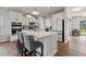 Bright kitchen featuring white cabinets, a large island with seating, modern appliances, and wood flooring at 260 Dunlin Dr, Summerville, SC 29486