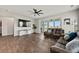 Spacious living room with sleek TV, modern furniture, wood floors, and scenic views from sliding glass doors at 260 Dunlin Dr, Summerville, SC 29486
