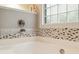 Close up of mosaic detailing in bathroom featuring a soaking tub and tiled backsplash at 2737 Old Forest Dr, Seabrook Island, SC 29455