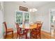 Cozy dining room with hardwood floors, a round wooden table, and natural light from the windows at 2737 Old Forest Dr, Seabrook Island, SC 29455
