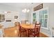 Bright dining room boasts hardwood floors, white trim, and a charming chandelier at 2737 Old Forest Dr, Seabrook Island, SC 29455