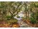 Attractive home exterior nestled among verdant trees, well-maintained landscaping, and a welcoming walkway at 2737 Old Forest Dr, Seabrook Island, SC 29455
