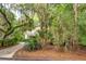 Home showcasing lush landscaping, mature trees draped with Spanish moss, and a well-maintained driveway at 2737 Old Forest Dr, Seabrook Island, SC 29455