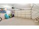 Spacious garage with ample storage shelves, colorful beach chairs, and a convenient garage door opener at 2737 Old Forest Dr, Seabrook Island, SC 29455