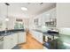 Charming kitchen with white cabinets, black countertops, stainless steel appliances, and natural light at 2737 Old Forest Dr, Seabrook Island, SC 29455