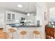 Bright kitchen featuring bar seating, white cabinets, granite countertops, and modern appliances at 2737 Old Forest Dr, Seabrook Island, SC 29455