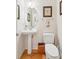 Cozy powder room with pedestal sink, oval mirror, and neutral decor at 2737 Old Forest Dr, Seabrook Island, SC 29455