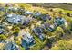 An aerial view of a neighborhood showcasing lush landscaping and golf course in the background at 278 Furman Farm Pl, Daniel Island, SC 29492