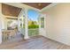 Inviting back porch features wooden flooring, a covered seating area, and view of the trees at 278 Furman Farm Pl, Daniel Island, SC 29492