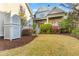Well-maintained backyard with manicured lawn, plantings, and partial view of the home at 278 Furman Farm Pl, Daniel Island, SC 29492