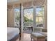 View from the bedroom onto a charming balcony with a table, chairs, and lush green scenery at 278 Furman Farm Pl, Daniel Island, SC 29492
