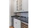 Stylish bar area with wine storage, black countertop, and decorative backsplash at 278 Furman Farm Pl, Daniel Island, SC 29492