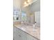 Bright bathroom with granite countertops and a large mirror to capture the natural light at 278 Furman Farm Pl, Daniel Island, SC 29492