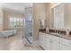 Bright bathroom featuring a glass shower, soaking tub, marble countertop, and elegant fixtures at 278 Furman Farm Pl, Daniel Island, SC 29492