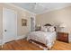 Cozy bedroom features a ceiling fan, crown molding and a decorative painting on the wall at 278 Furman Farm Pl, Daniel Island, SC 29492