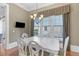 Bright dining room with a white table set, chandelier, and natural light at 278 Furman Farm Pl, Daniel Island, SC 29492