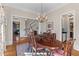 Traditional dining room with hardwood floors, chandelier and decorative rug and elegant stairway at 278 Furman Farm Pl, Daniel Island, SC 29492