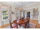 Beautiful dining room with hardwood floors, chandelier, decorative rug, and light-filled windows at 278 Furman Farm Pl, Daniel Island, SC 29492