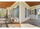 Charming home exterior boasts black window shutters and a shaded outdoor porch area at 278 Furman Farm Pl, Daniel Island, SC 29492