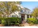 Beautiful two-story home featuring a manicured lawn and mature trees at 278 Furman Farm Pl, Daniel Island, SC 29492