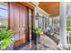 Elegant entryway features a rich wood door, covered porch, and stylish decor at 278 Furman Farm Pl, Daniel Island, SC 29492
