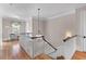 Bright hallway featuring hardwood floors, staircase, chandelier, and a charming window seat at 278 Furman Farm Pl, Daniel Island, SC 29492