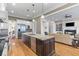 Open kitchen featuring stainless appliances and a large island adjacent to the living room at 278 Furman Farm Pl, Daniel Island, SC 29492