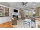 Comfortable living room with fireplace, built-in shelving, and access to the patio at 278 Furman Farm Pl, Daniel Island, SC 29492
