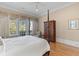 Cozy main bedroom featuring a four-poster bed, decorative drapes, and scenic views from the window at 278 Furman Farm Pl, Daniel Island, SC 29492