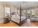 Spacious main bedroom with hardwood floors, a four-poster bed, and access to a private balcony at 278 Furman Farm Pl, Daniel Island, SC 29492