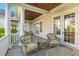Charming covered patio with comfortable seating and outdoor dining area; an ideal space for entertaining at 278 Furman Farm Pl, Daniel Island, SC 29492