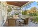 Inviting covered porch with wood ceiling, ceiling fan, and comfortable wicker furniture at 278 Furman Farm Pl, Daniel Island, SC 29492