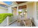 Relaxing covered porch area with wooden table set and adjacent grilling station at 278 Furman Farm Pl, Daniel Island, SC 29492