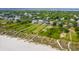 Panoramic aerial view of a coastal community, highlighting beach access and houses with lush landscaping and serene neighborhood charm at 2906 Palm Blvd, Isle of Palms, SC 29451