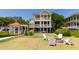 Beautiful backyard with a gazebo, fire pit with chairs, and lush green lawn, perfect for entertaining at 2906 Palm Blvd, Isle of Palms, SC 29451
